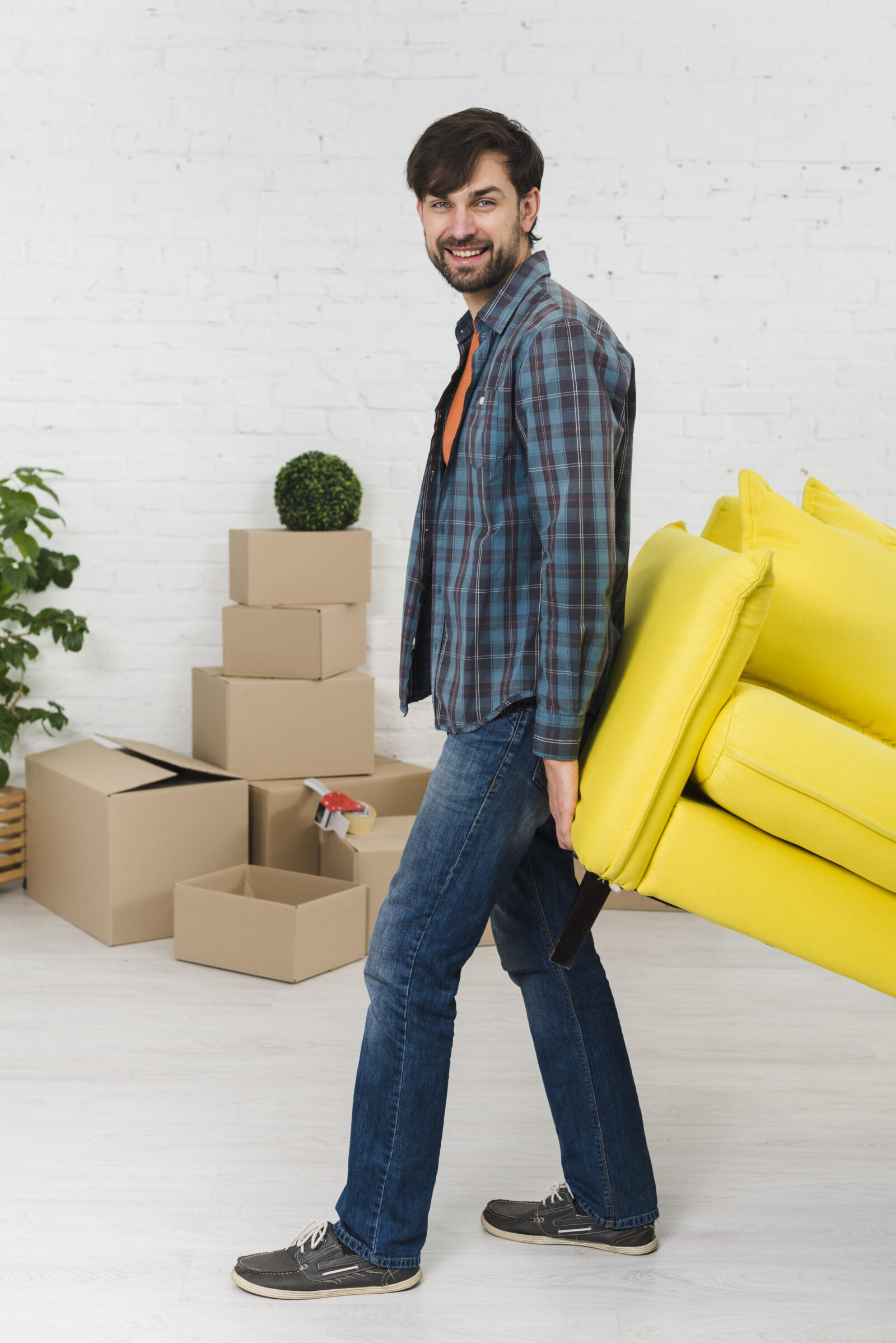 smiling-portrait-young-man-lifting-yellow-sofa-new-house smiling-portrait-young-man-lifting-yellow-sofa-new-house